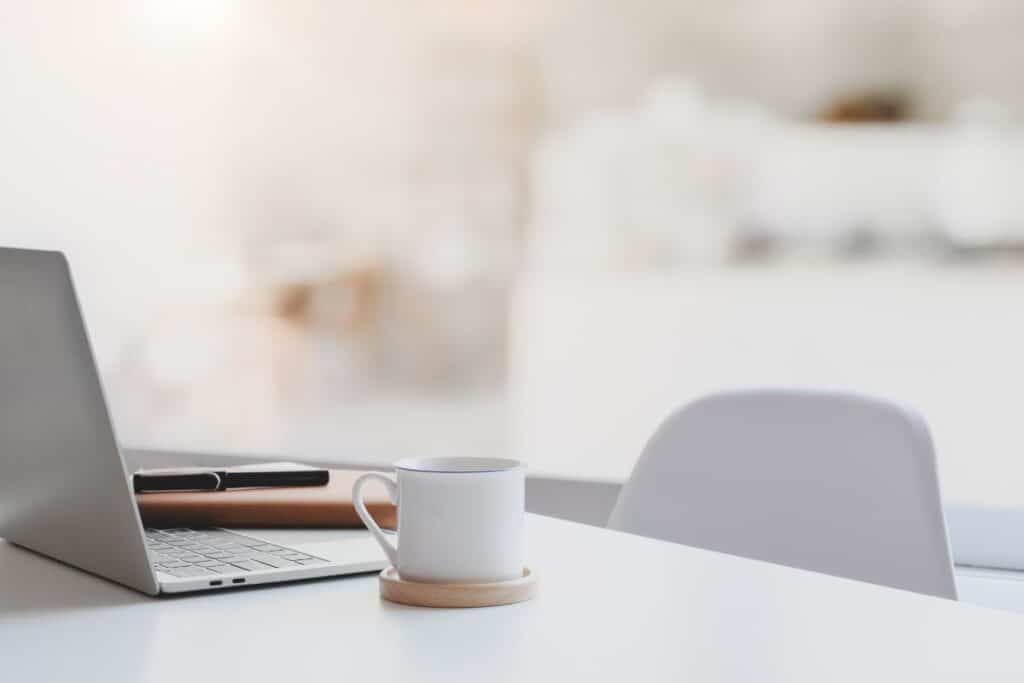 Foto de mesa organizada com laptop e xícara de café